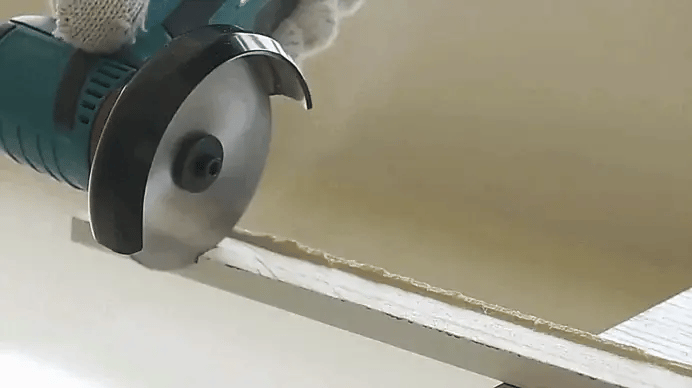 12V Mini Angle Grinder cutting metal with high-speed 19500 RPM blade for precise grinding tasks