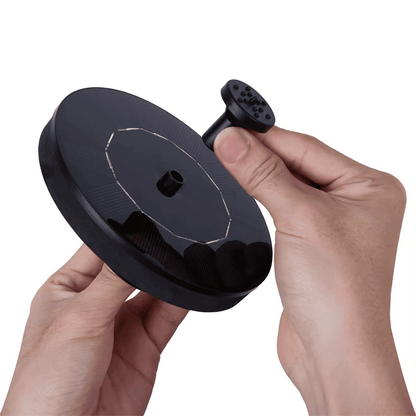 Hands installing the removable nozzle on the compact round solar fountain pump